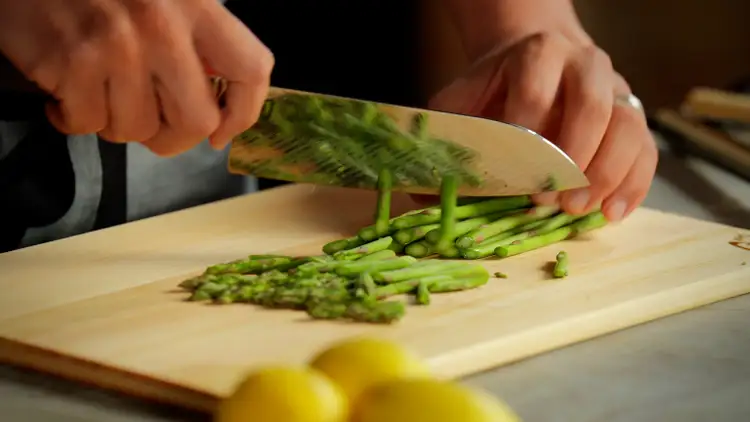 Chef Kim slices asparagus with a Dual Core Santoku.