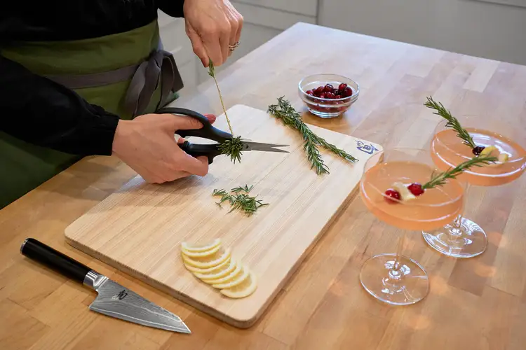 Stripping rosemary needles using the notch on a pair of Shun herb shears.