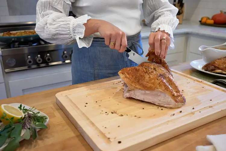 Detaching a turkey wing from the breast using the Shun Kazahana Utility Knife.