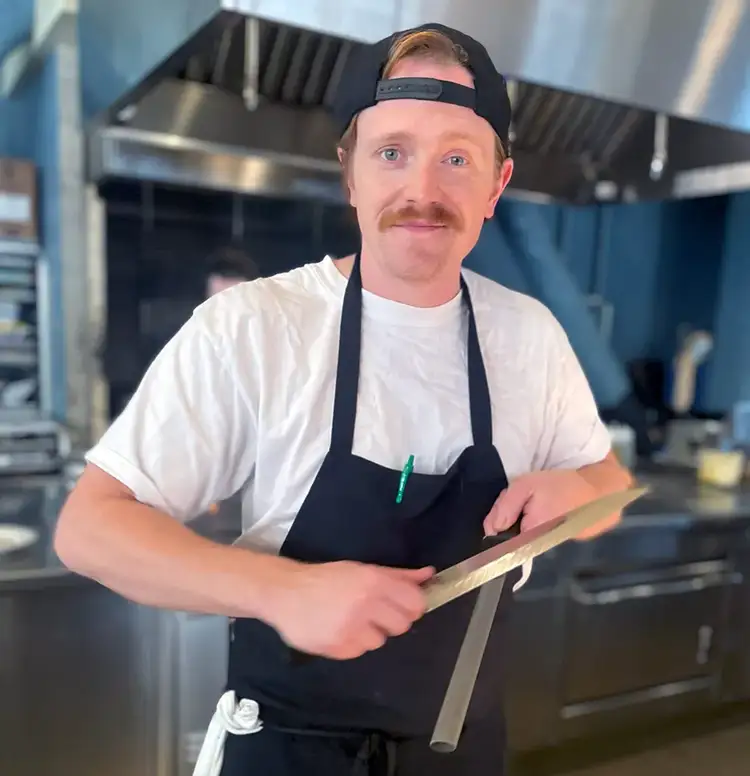 Chef Mike Conrad stands in his kitchen at Restaurant Lena in Detroit. Click to read his interview.