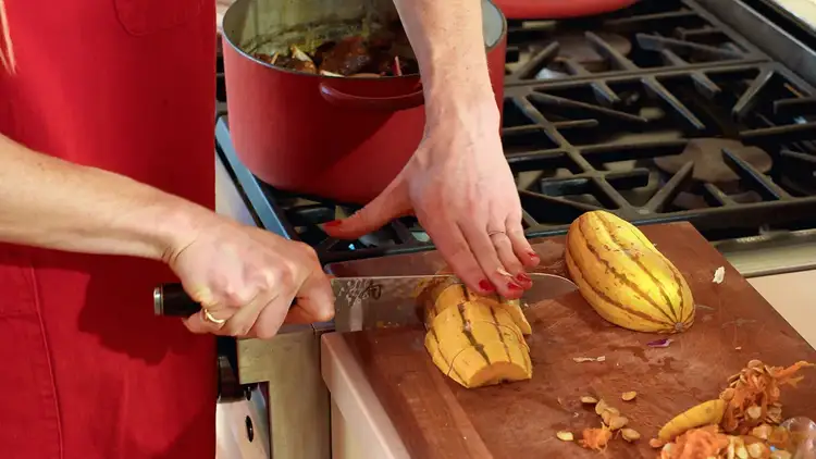 Molly Baz slices squash for her braised spare ribs.