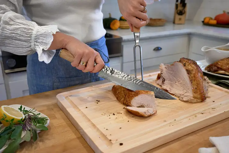 Slicing roasted turkey breast into thick slices with the Shun Premier Carving Knife.