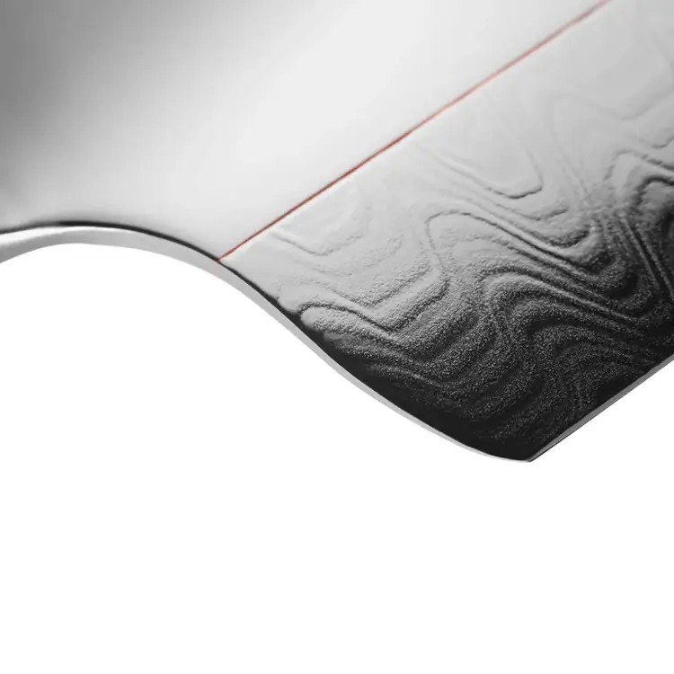 Close-up view of the Shun Kagerou Chef's Knife blade showcasing the transition between the Damascus steel cutting edge and polished upper blade with copper accent.