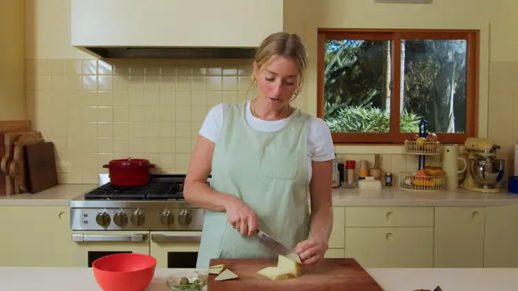Molly Baz slices cheese for her Gilda Grilled Cheese Sandwich.