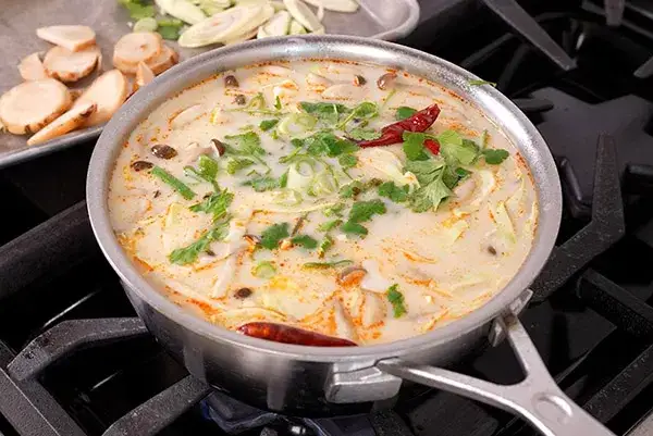 Coconut chicken soup in a pot on the stove