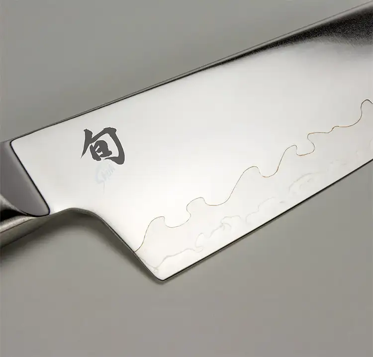 Detailed close-up of the Shun Sora blade showing the wavy hamon line where two steels meet, emphasizing the composite blade construction.