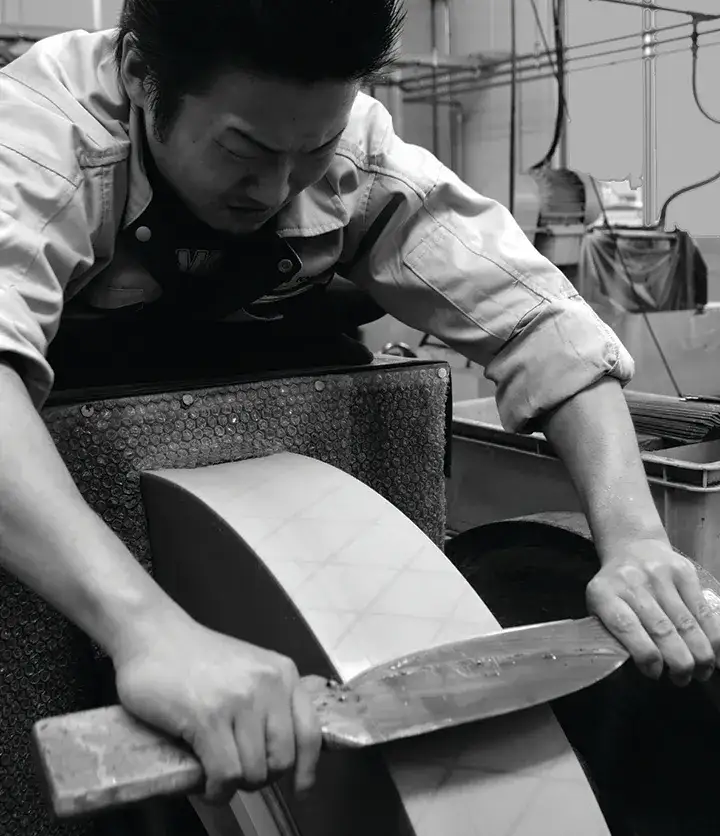 Man grinding knife