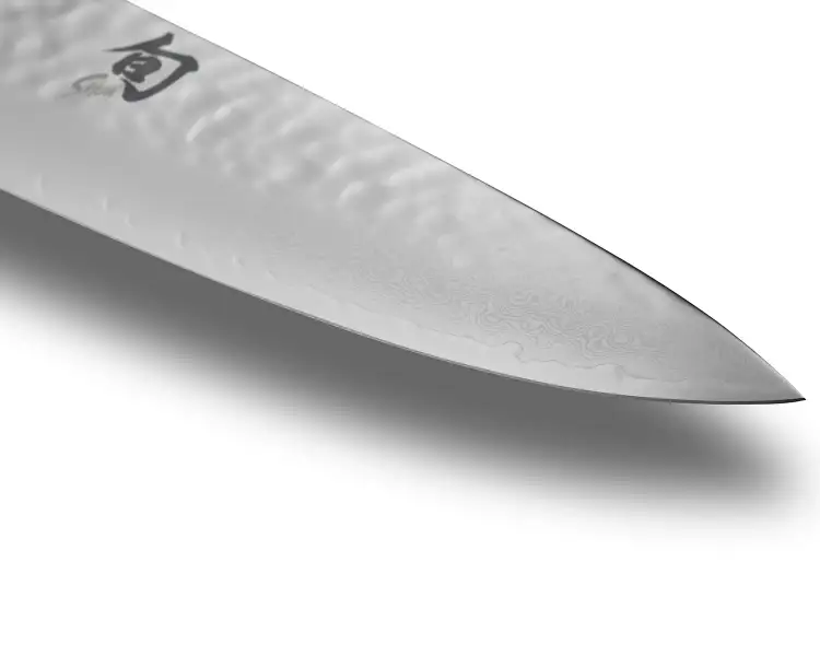 Close-up of a Shun knife blade showing refined edge geometry and layered Japanese steel craftsmanship.