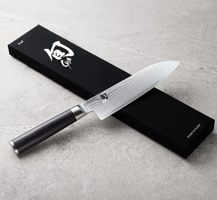 Classic Santoku resting on top of a Shun box.