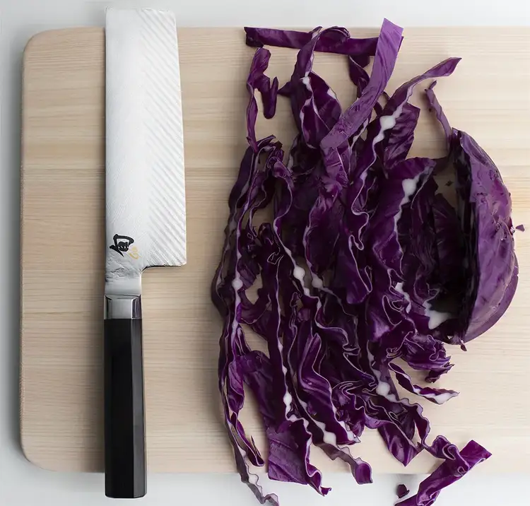A Dual Core Nakiri sits next to a shredded purple cabbage. Click to shop the Dual Core Nakiri.