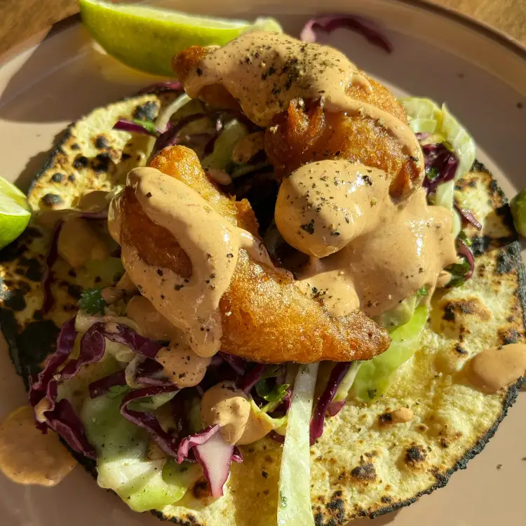 Beautifully cooked crispy shrip tacos basking in the evening sun.
