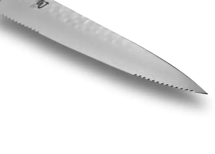 Premier Utility Knife blade detail showing smooth edge flanked by serrated heel and tip.