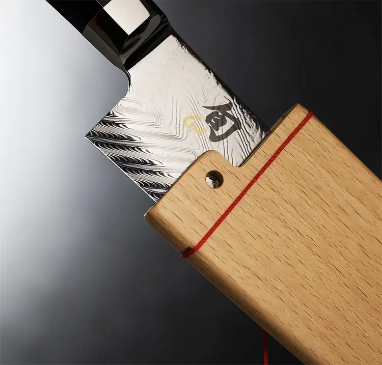A Dual Core Kiritsuke is being removed from its wooden saya. Click to shop the Dual Core Kiritsuke.