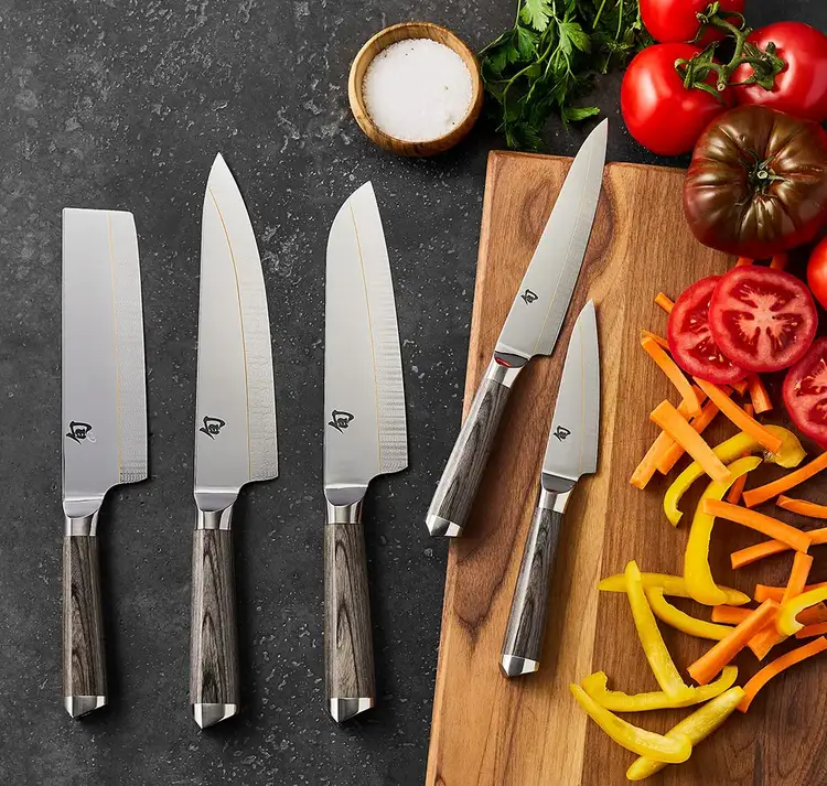 Group of Shun Kagerou knives featuring ladder-bar blade patterns and mirror-polished upper blades.