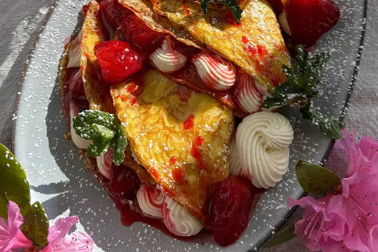 Close up of deliciously stuffed Strawberry Cheesecake Crepes - click for the recipe page.