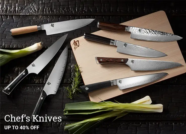 A grouping of Shun Chef's Knives lying next to ribbons and bows.
