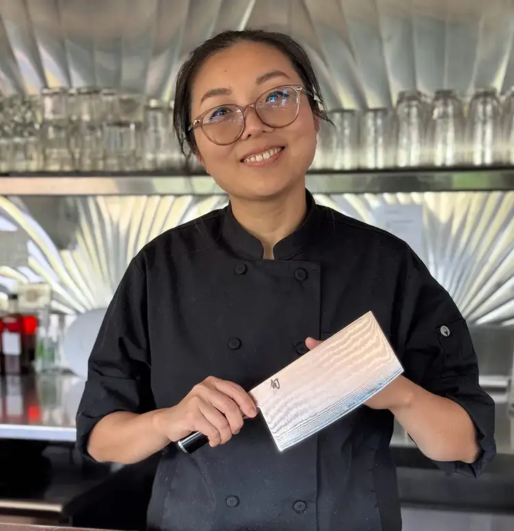 Chef Liu Fang holds a Shun Classic Vegetable Cleaver. Click to read her interview.