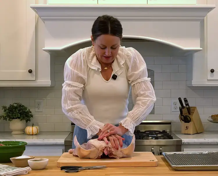 Andrea Slonecker spatchcocks a turkey for roasting.