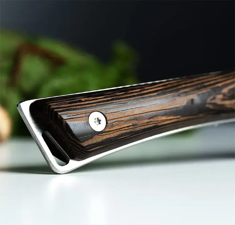 Macro shot of the Kanso knife handle made from Tagayasan wood, revealing wood grain texture, ergonomic shaping, and exposed tang.